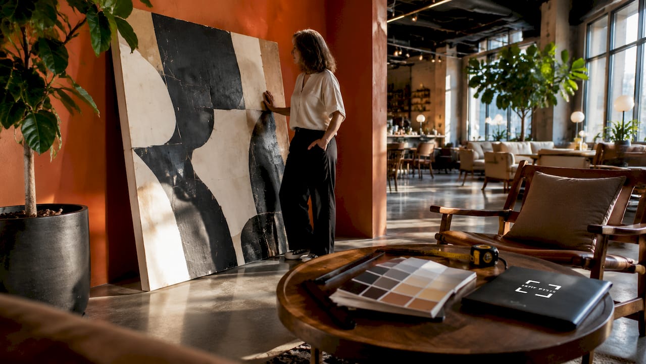 Interior designer measuring oversized wall art