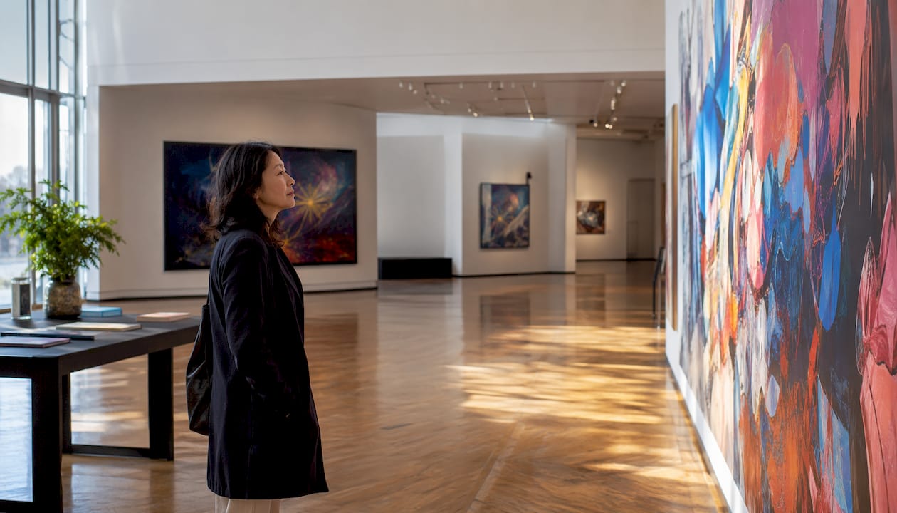 Woman viewing mural in corporate lobby